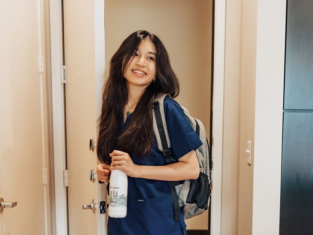 woman in scrubs coming home to her Lodgeur flexible, furnished apartment