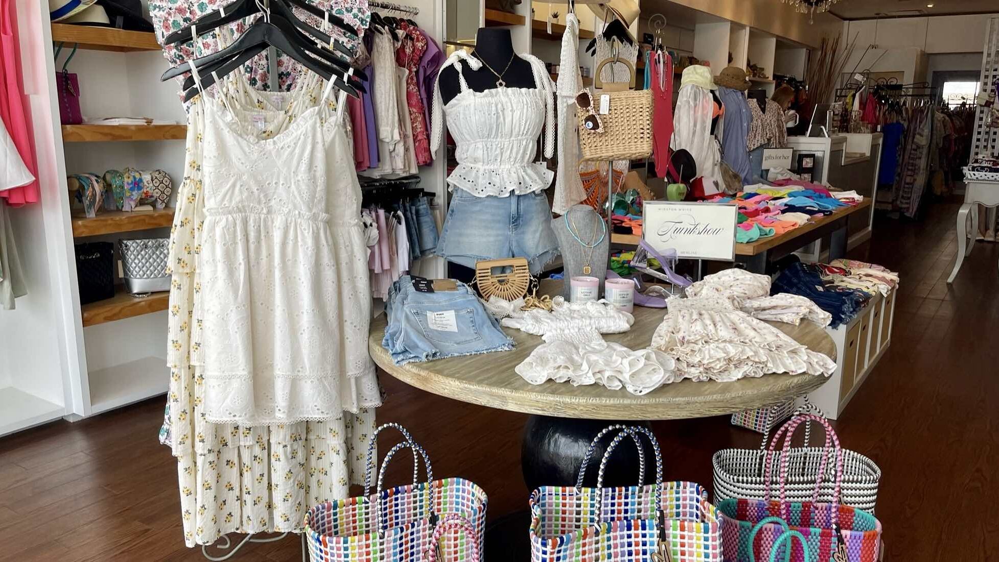 Clothes and bags on display at a retail store.