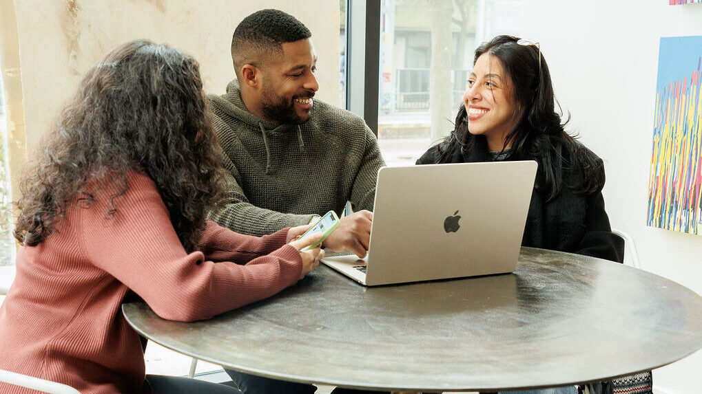 three young professionals at a table