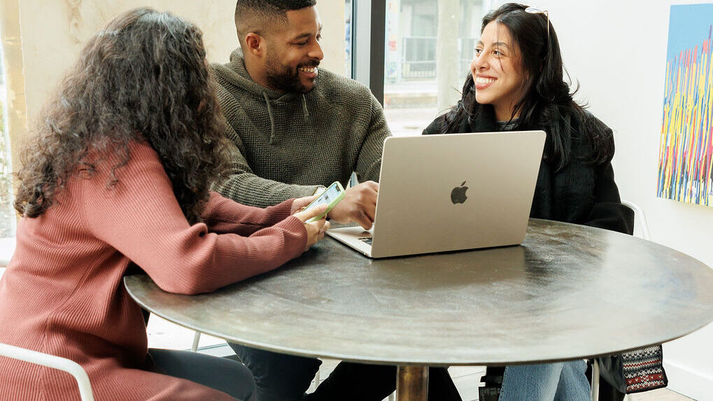 three young professionals at a table