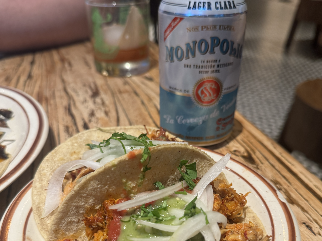 BBQ tacos on a plate partnered with can of beer